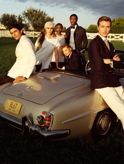 Models around Mercedes convertible wear black and white Ralph Lauren attire.