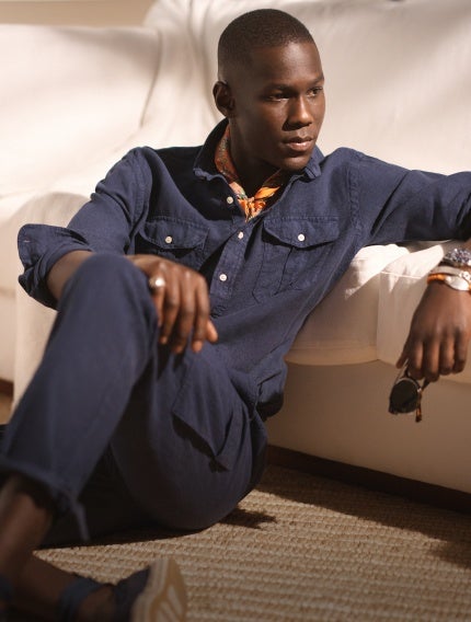 Man wears navy linen button-down and pants