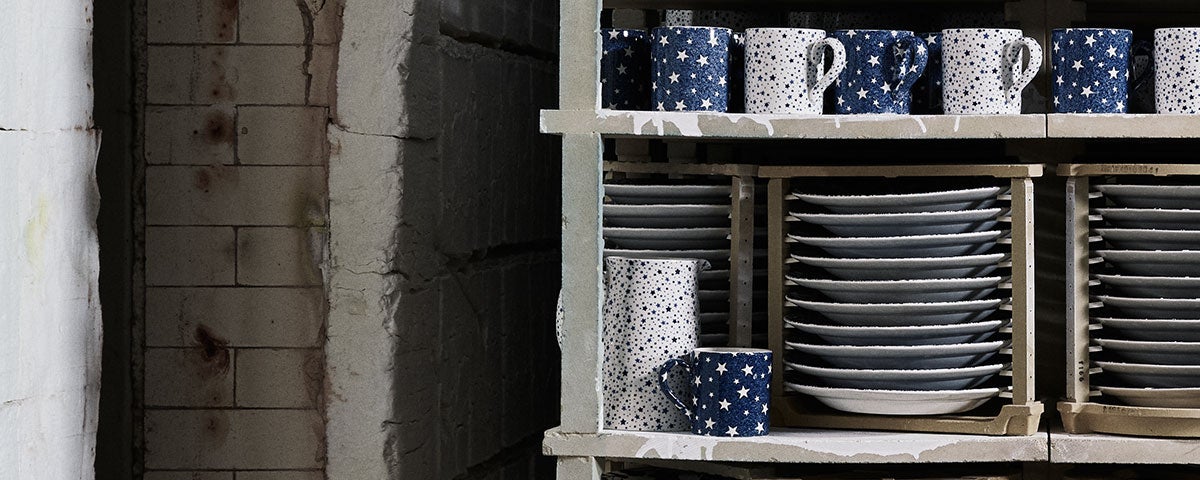 Shelves filled with navy & white star-print mugs and dishes