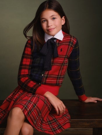Girl wears plaid dress with peter pan collar.
